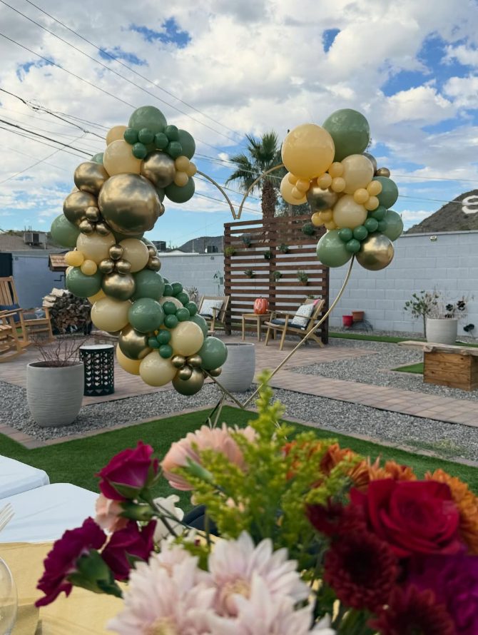 Green and gold outdoor balloon arch by AZ Party Mart