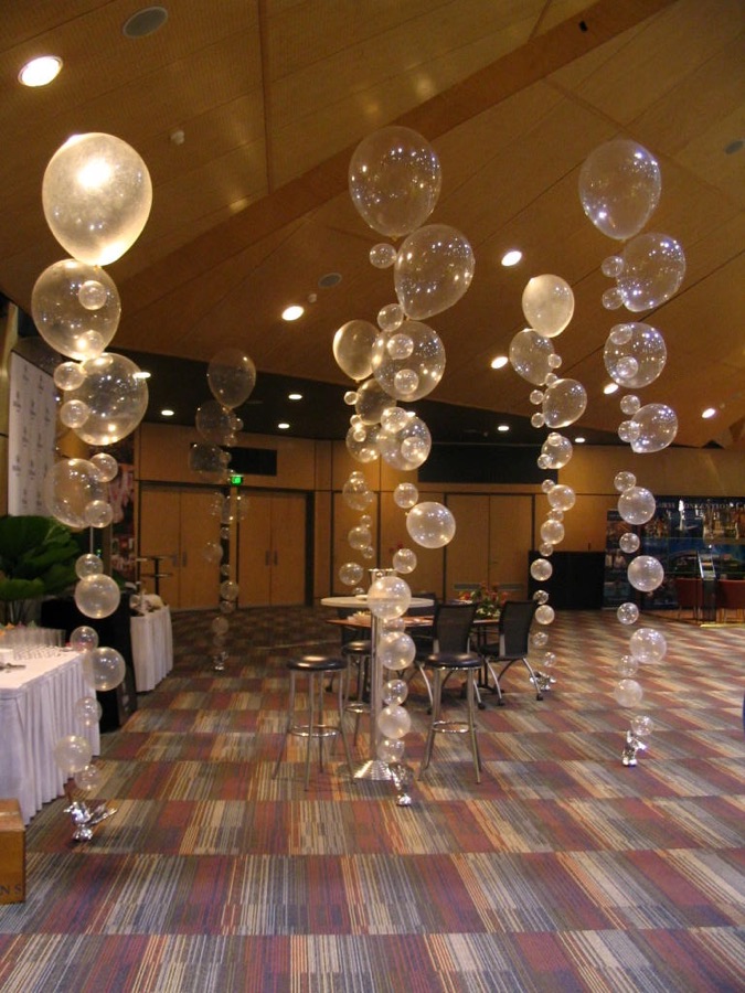 Clear and gold bubble balloon columns in a banquet hall by AZ Party Mart