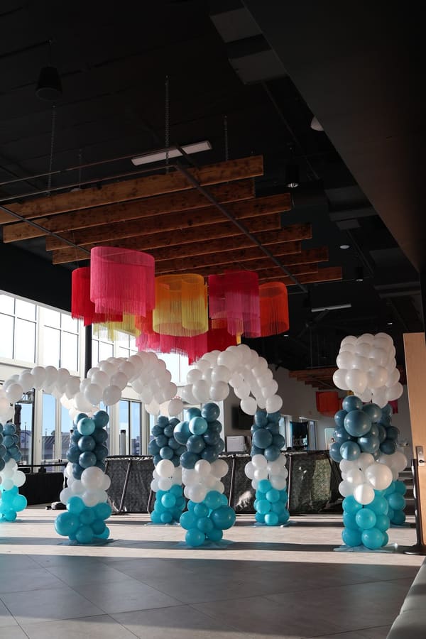 Teal and white balloon columns by AZ Party Mart