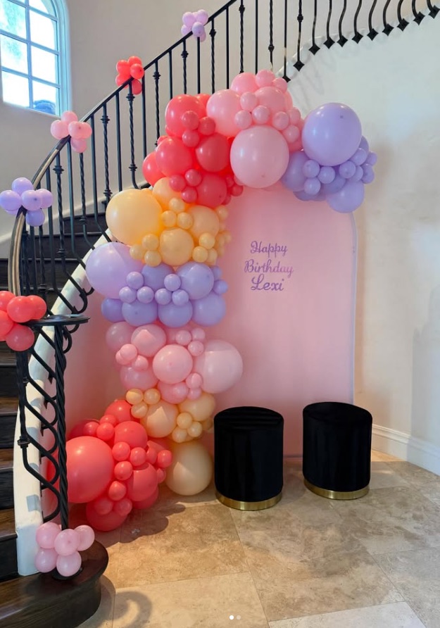 Pastel organic balloon garland flowing down a staircase