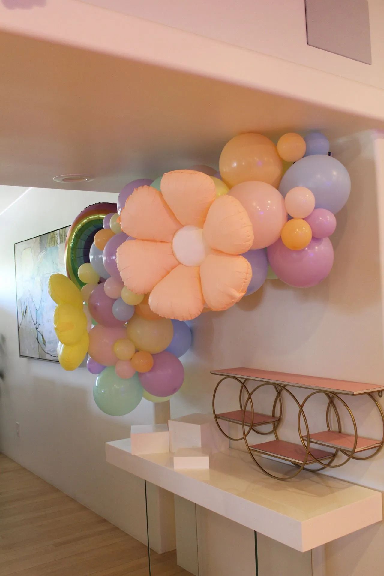 Pastel flower balloon installation in a hallway