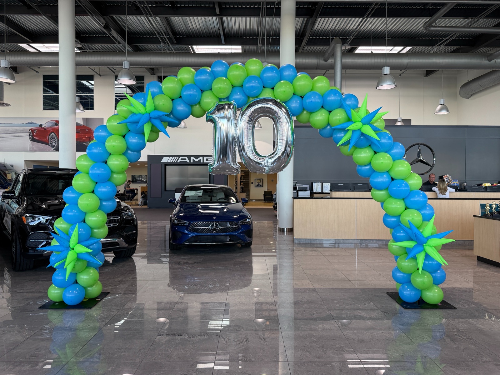 Blue and green balloon arch in a showroom by AZ Party Mart